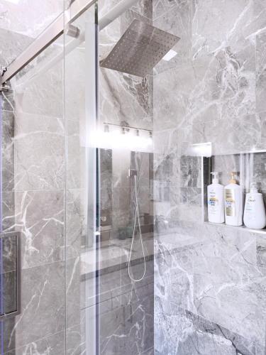 a bathroom with a shower with a glass door at Newly Remodeled Pool Villa-Fast WiFi -Summerlin in Las Vegas