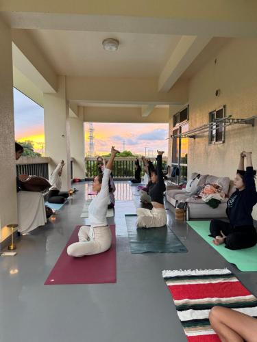 a group of people doing yoga in a room at okinawa sup guide in Kunigami