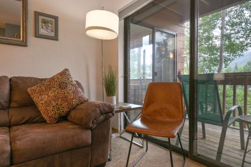 a living room with a couch and a table at Lagoon Royal Townhome: Mountain Views Meet Modern Comforts in Frisco
