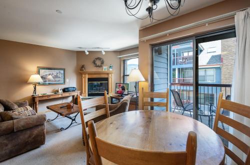 a living room with a table and chairs and a couch at River Mountain Lodge Peaks Trail Condo: Ski-In, Downtown Breck in Breckenridge