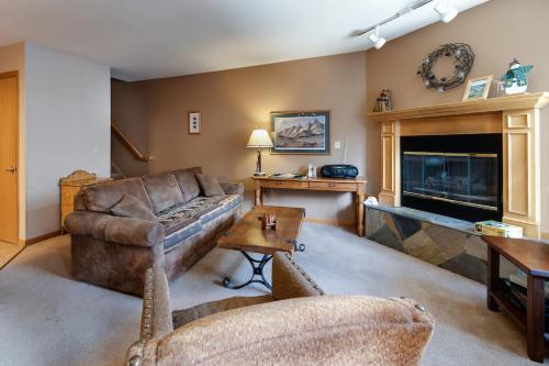a living room with a couch and a fireplace at River Mountain Lodge Peaks Trail Condo: Ski-In, Downtown Breck in Breckenridge