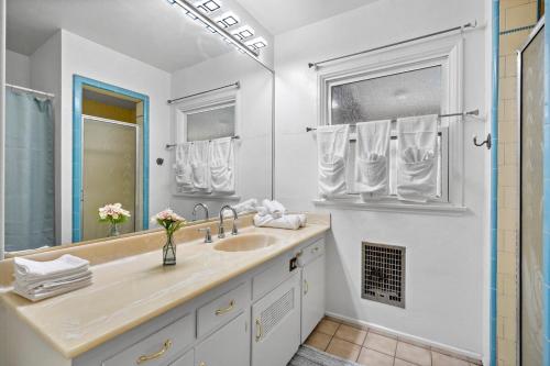 une salle de bain blanche avec un lavabo et un miroir dans l'établissement Hot Tub - Pool - FirePit - GameRoom - Sleeps 12!, à Riverside