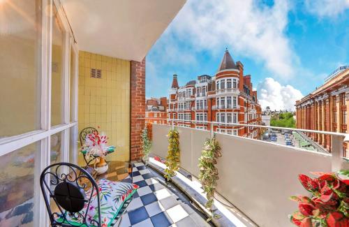 a balcony with a bench and a view of a building at PANORAMIC Apartment with Terrace on HARRODS in London
