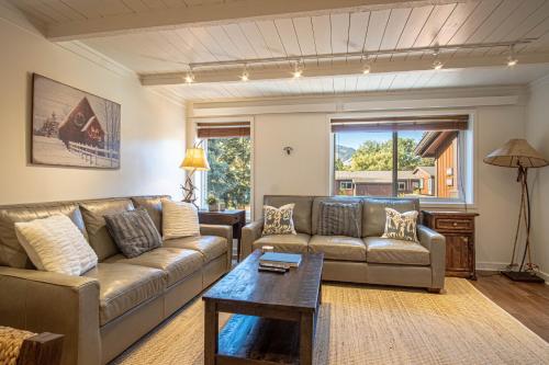 a living room with a couch and a coffee table at Atelier Alpine - Modern 2BD Condo w/Baldy Views in Sun Valley