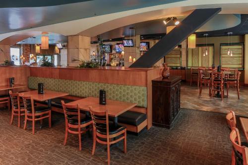a restaurant with tables and chairs and a bar at Grand Harbor Resort and Waterpark in Dubuque