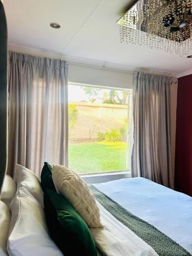 a bedroom with a bed in front of a window at Suider home stay in Johannesburg