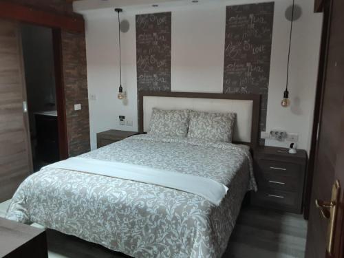 a bedroom with a large bed with a gray and white bedspread at RUBYAi in Icod el Alto