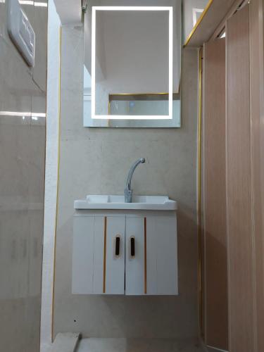 a bathroom with a white sink and a mirror at Stone house in Amman