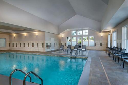 a pool in a hotel with chairs at Residence Inn Dallas DFW Airport South/Irving in Irving
