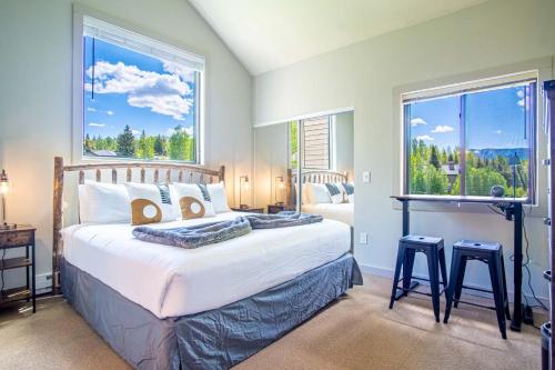a bedroom with a bed with a large window at Modern Golf View Condo + Resort Amenities in Sun Valley