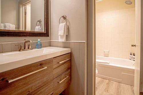 a bathroom with a sink and a bath tub at Modern Golf View Condo + Resort Amenities in Sun Valley