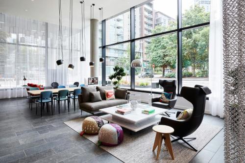 a living room with a couch and chairs and a table at citizenM Seattle South Lake in Seattle