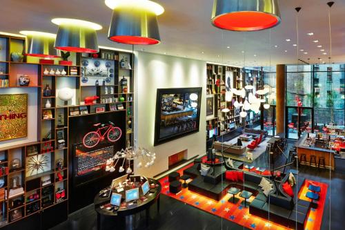 a room filled with lots of furniture and lights at citizenM New York Times Square in New York