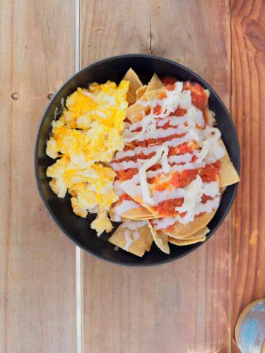 a bowl of food with nachos and cheese on a table at Friducha en Barrio Antiguo Mty in Monterrey