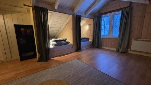 an empty room with two beds in the attic at Fox Cabin in Lyngen