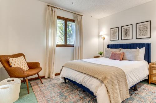 a bedroom with a bed and a chair and a window at 4 Mi to Capitol Spacious Springfield Home with Deck in Springfield