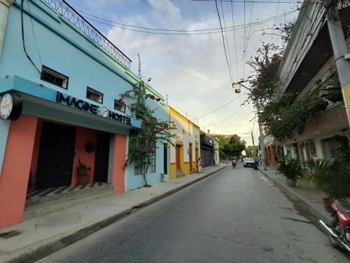 an empty street in a city with buildings at Imagine hostel in Santa Marta