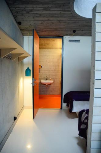 a room with a bathroom with a sink and a door at Støkkøya Strandhotell in Hosen