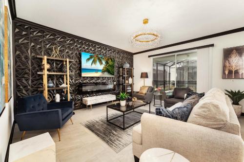 a living room with a couch and a table at New Beautiful 7 br w pool games theme rooms in Kissimmee