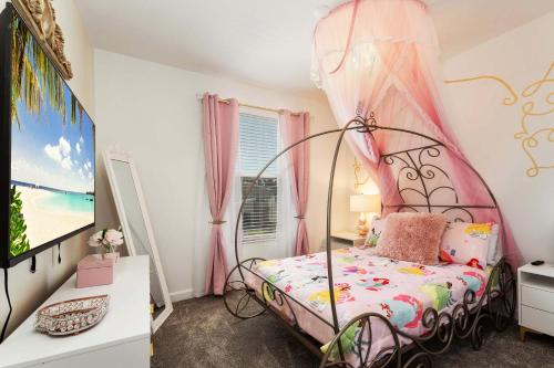 a bedroom with a bed with a canopy at New Beautiful 7 br w pool games theme rooms in Kissimmee