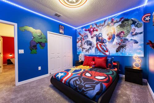 a superhero themed bedroom with a superhero mural at New Beautiful 7 br w pool games theme rooms in Kissimmee