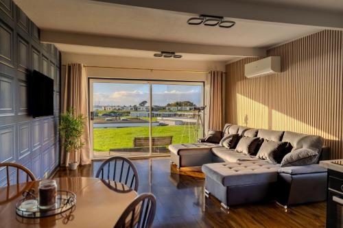a living room with a couch and a table at Romantic Seaside Chalet Retreat Solent Breezes in Warsash