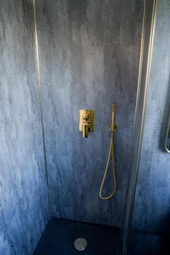 a bathroom with a shower with a hose on the wall at Romantic Seaside Chalet Retreat Solent Breezes in Warsash