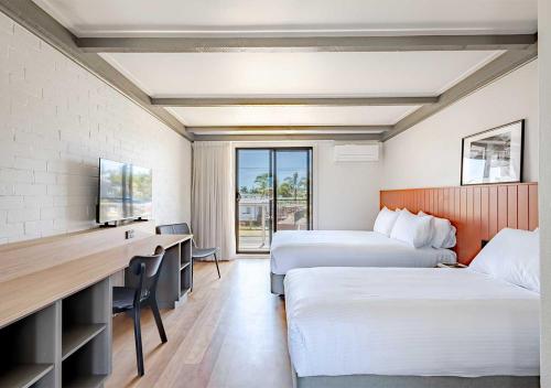 Ένα ή περισσότερα κρεβάτια σε δωμάτιο στο Tween Waters Merimbula