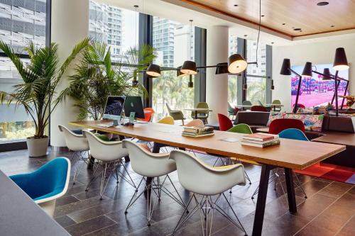 a conference room with a large wooden table and chairs at citizenM Miami Brickell in Miami