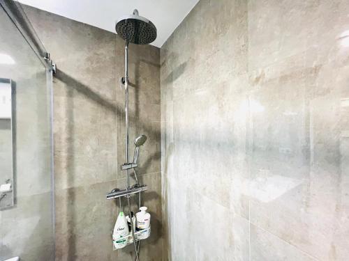 a bathroom with a shower with two bottles of soap at Pradollano LUXUS Grandes vistas in Sierra Nevada