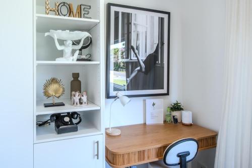 a home office with a desk and a mirror at Sage Studio in Alstonville