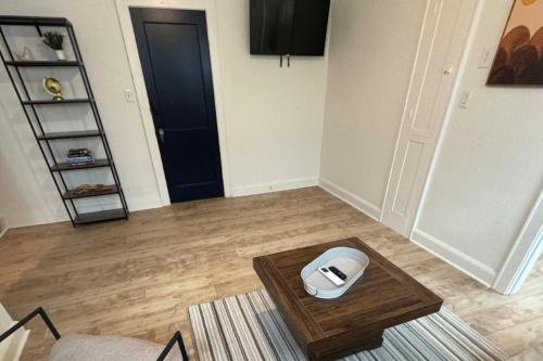 a living room with a table with a dog bowl on it at Fully Furnished Monthly Stay or Weekend Getaway in Hot Springs