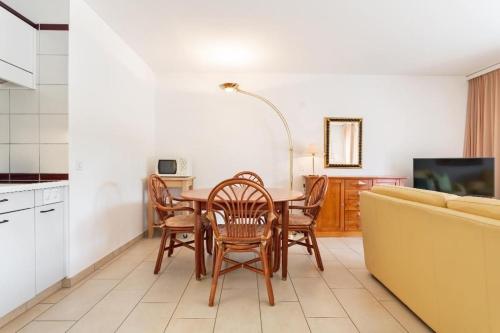 uma cozinha com uma mesa e cadeiras e um sofá em Golf Ranch, 1Er Stock em Ascona