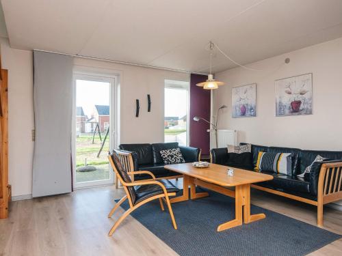 a living room with a couch and a table at 6 person holiday home in Rømø in Rømø Kirkeby