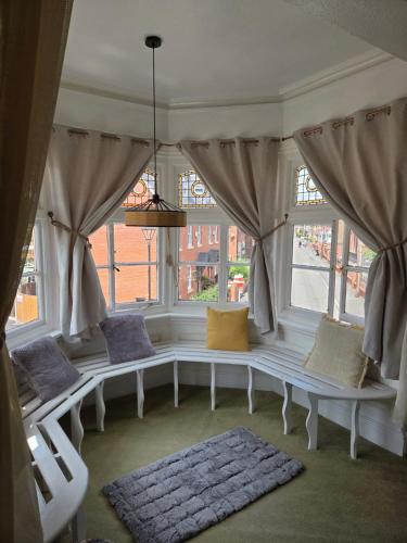 a window seat in a living room with pillows at The Stokesay Inn in Craven Arms
