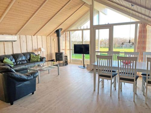 a living room with a couch and a table at 5 star holiday home in Vestervig in Vestervig