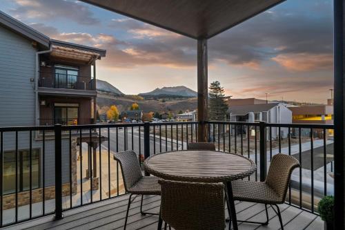 a patio with a table and chairs on a balcony at Skywalk Flats Mountainview Condo: Downtown, Rooftop Hot Tubs in Silverthorne