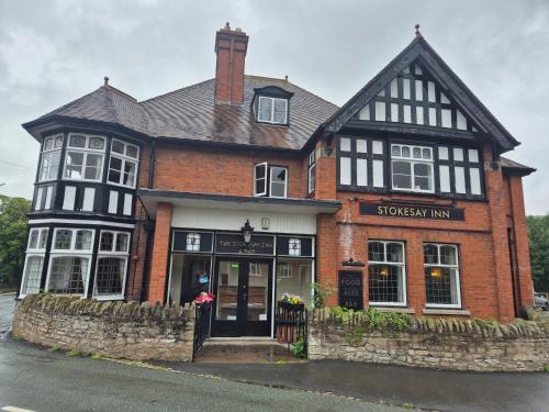 a brick building with a black and white at The Stokesay Inn in Craven Arms