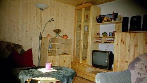 a living room with a couch and a tv at Ferienhaus Mit Bergblick in Harztor