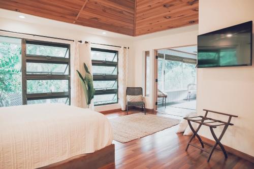a bedroom with a bed and a large window at Loi B&B in Hilo