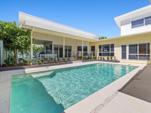 a swimming pool in the backyard of a house at Splash House at Kingscliff - Pet Friendly with Pool in Kingscliff