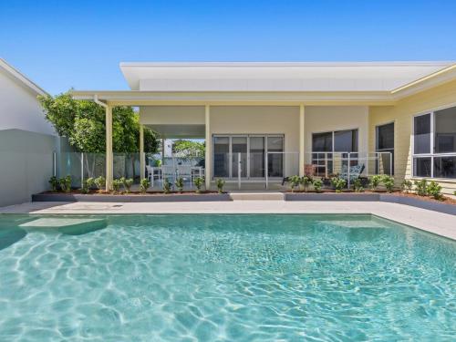 a swimming pool in front of a house at Splash House at Kingscliff - Pet Friendly with Pool in Kingscliff