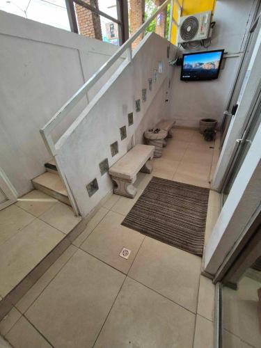 a staircase in a building with benches and a tv at La cueva in Monterrey