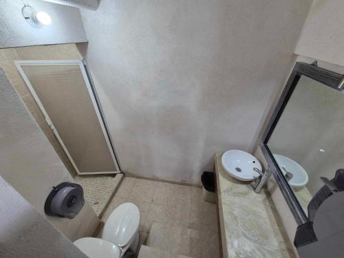 a bathroom with a shower and a toilet and a sink at La cueva in Monterrey