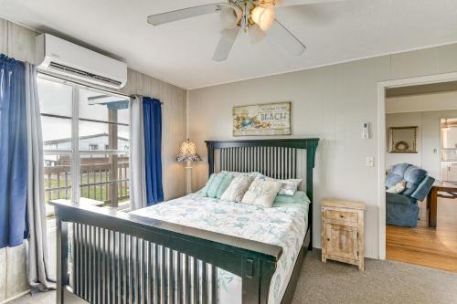 a bedroom with a bed and a balcony at Ocean Views Second-Row Surfside Beach House in Surfside Beach