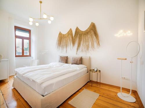 a white bedroom with a large white bed in it at Family-Friendly Apartment in Graz in Graz Ostbahnhof