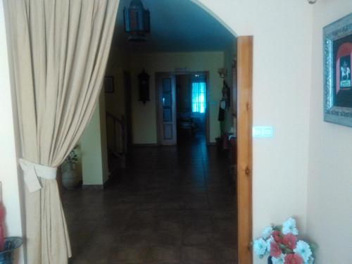 a hallway with a door and a curtain in a house at Fuerte de San Mauricio in Palazuelo de Vedija