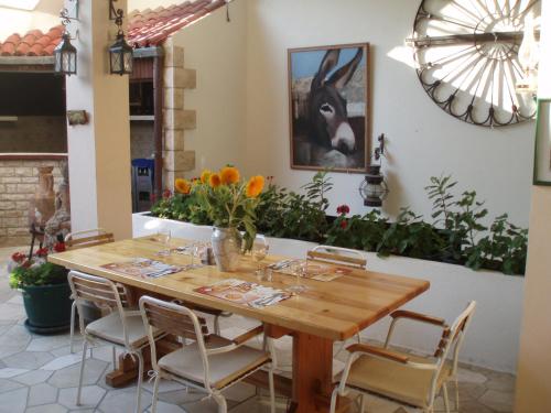 a dining room with a wooden table and chairs at Pension Oaza in Hvar
