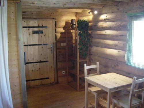 a wooden room with a table and a door at Log Cabin in the Loire Valley in Ambillou-Château
