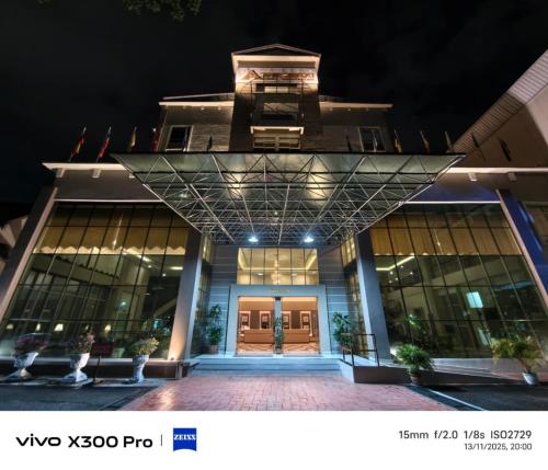 a large building with a large glass door at night at The Jerai Hotel Sungai Petani in Sungai Petani